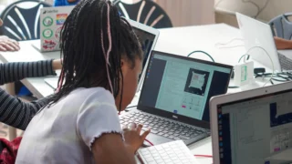 A young learner coding on a computer for Mission Zero
