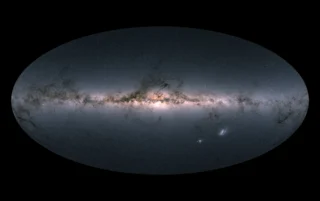Gaia’s all-sky view of our Milky Way Galaxy and neighbouring galaxies, based on measurements of nearly 1.7 billion stars. The map shows the total brightness and colour of stars observed by the ESA satellite.