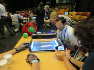 Teachers at a workshop surrounding a cloud chamber using off-the-shelf materials.